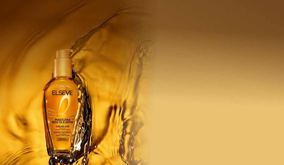 Butelka olejku Elseve Magiczna Moc Olejków od L’Oréal Paris umieszczona na lśniącej, wodnej powierzchni.